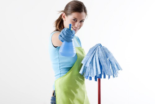 Living room sofa cleaning preparation with vacuum and cushions