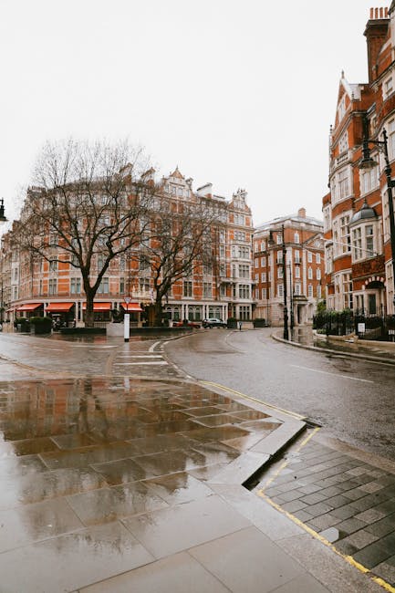 The image depicts the exterior of a restaurant situated on Crispin Street, with a prominent red-brown facade and large glass windows revealing warm interior lighting. In front of the establishment, th